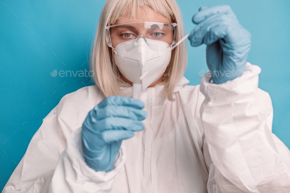 Covid 19 pcr test. Doctor in protective suit medical mask gloves holding Swab saliva sample