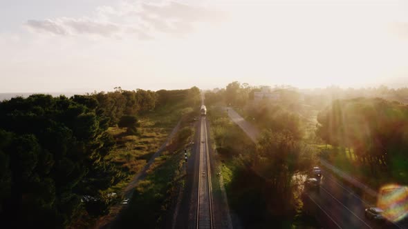 Aerial view of a railway at sunset time. alt