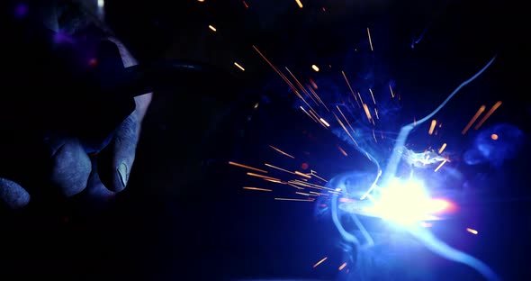 Close-up of welder working on a piece of metal alt