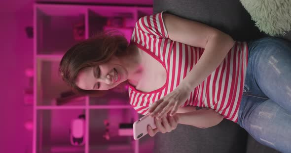 Woman in the Evening Tapping on the Smartphone While Shopping Online and Paying With a Credit Card alt