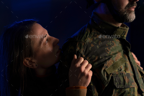 Sad woman doesn't want to let her husband go to fight in war