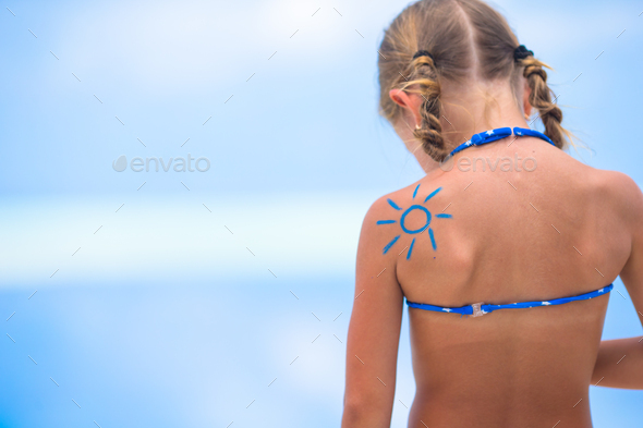Sun painted by sun cream on kid shoulder - Stock Photo - Images