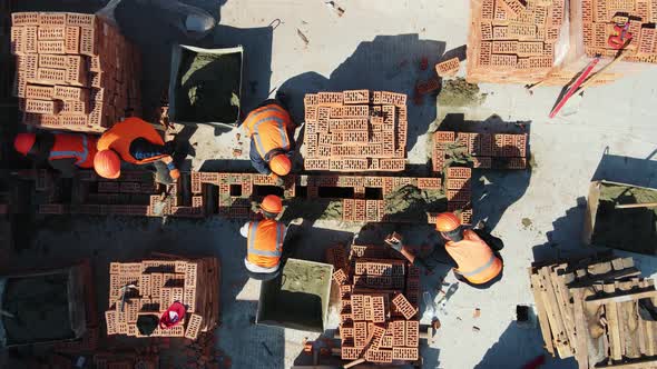 Aerial Top View of Builders Building a House alt