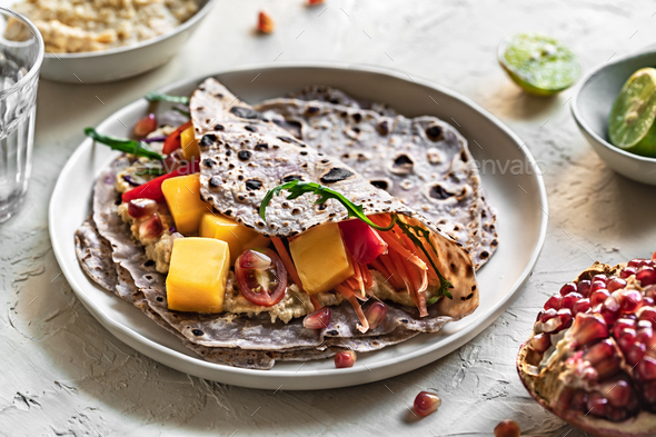 Sweet Purple Tortilla with Mango Carrot Pomegranate and Hummus - Stock Photo - Images