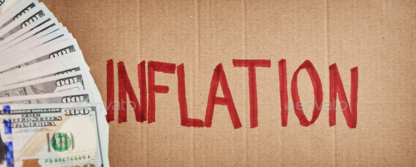 World inflation concept. Cardboard with word inflation and usd banknotes - Stock Photo - Images