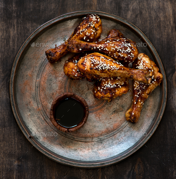 Grilled chicken drumstick with sesame and soy sauce Stock Photo by NoShanti