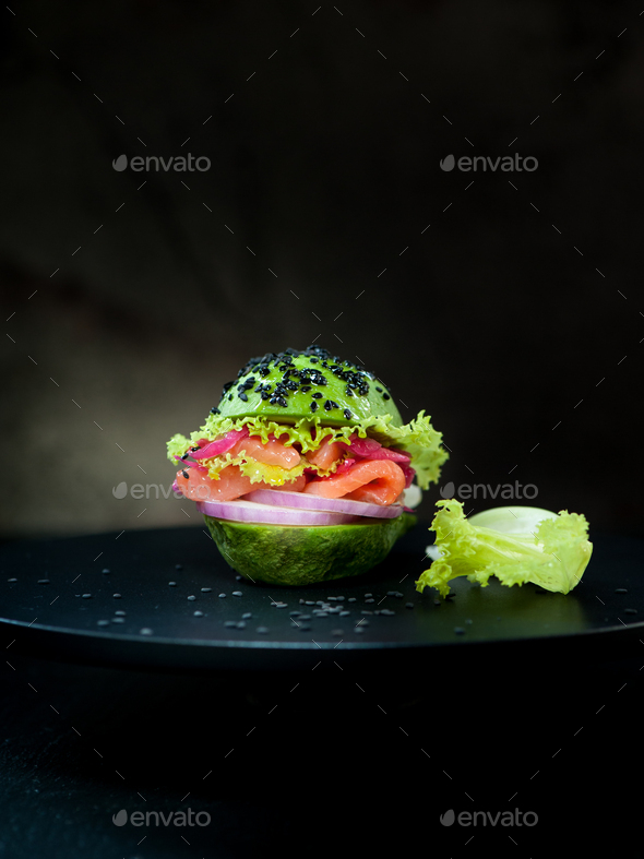 Avocado burger with salmon and vegetables. healthy vegan food concept