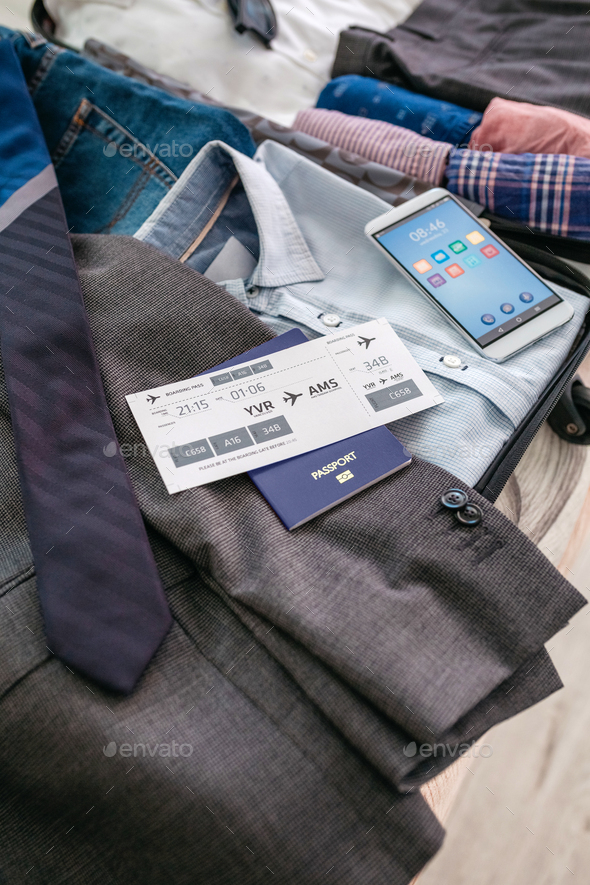 Boarding pass and passport in businessman's suitcase - Stock Photo - Images