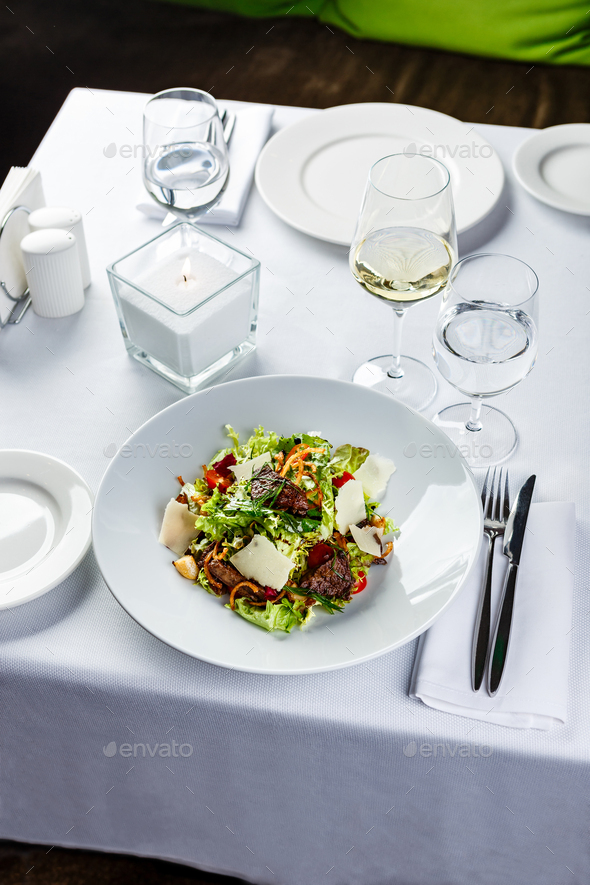 Warm salad with grilled chicken liver and parmesan. Restaurant serving
