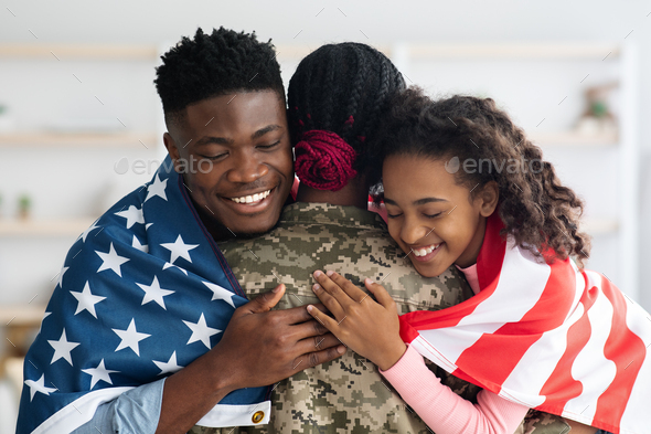 Patriotic black family greeting their mother soldier, closeup photo