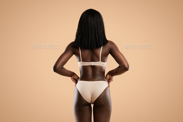 Cropped Shot Of Slim African American Woman In Underwear Over Beige  Background Stock Photo by Prostock-studio