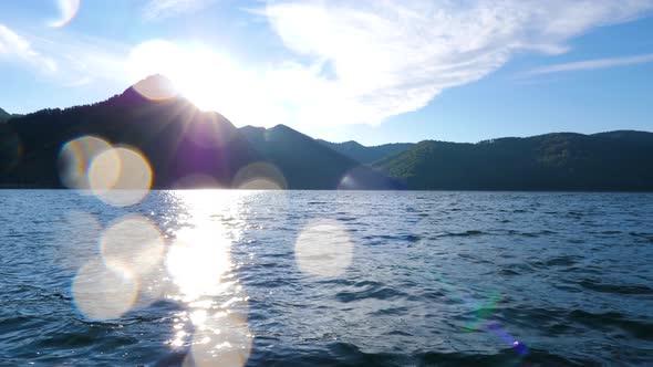 Mountain lake with big waves caused by wind. Beautiful mountain lake. Sailing on a mountain lake. alt