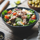 Canned tuna salad with fresh vegetables, capers and olives in a black bowl. - PhotoDune Item for Sale