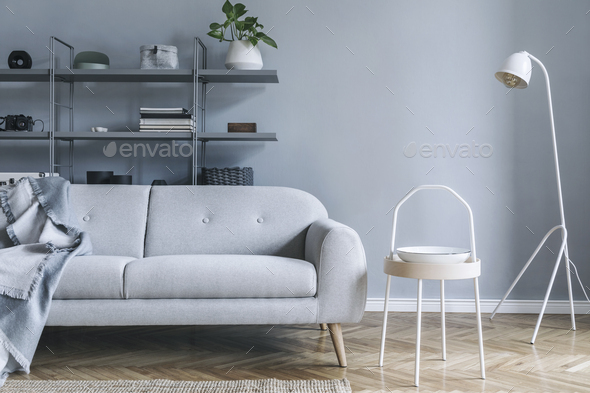 Stylish nordic living room with design grey sofa.