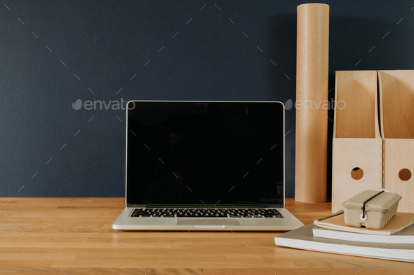 Laptop on wooden desk with office accessories - Stock Photo - Images