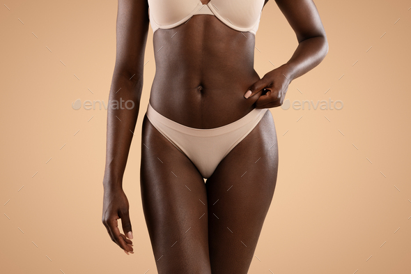 Stockfoto Black woman, underwear model and body in fashion studio
