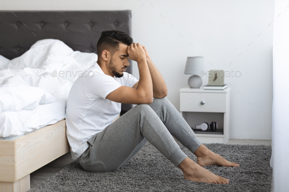 Life Troubles. Depressed Pensive Young Arab Man Sitting On Floor Near ...