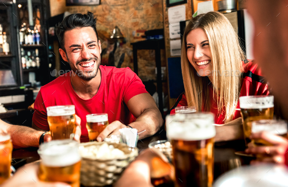 Happy couple drinking beer at brewery bar with friends Stock Photo by ...