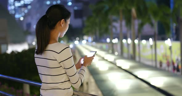 Woman use of smart phone in city alt