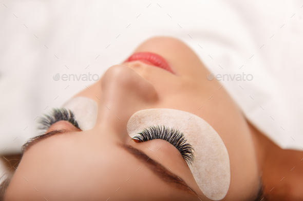 Eyelash Extension Procedure. Woman Eye with Long Eyelashes. Close up, selective focus - Stock Photo - Images