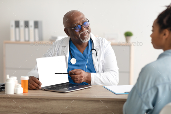 Experienced black doctor explaining treatment plan to female patient