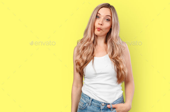 Silly young woman making fish face isolated on color background