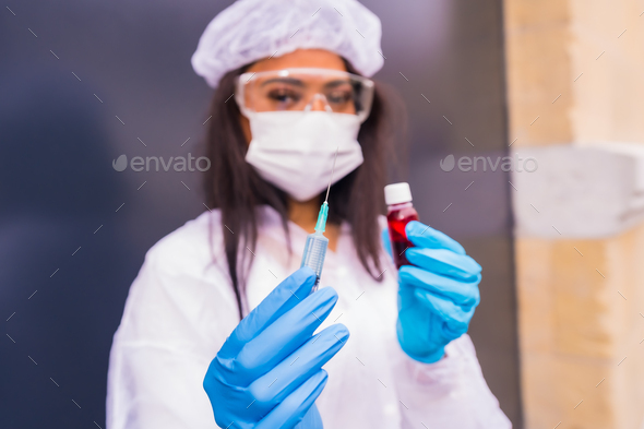 African-American doctor with the coronavirus vaccine in her hands