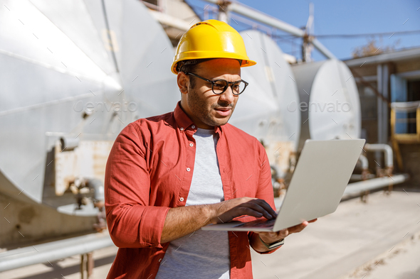 Experienced worker concentrating at his work in plant - Stock Photo - Images