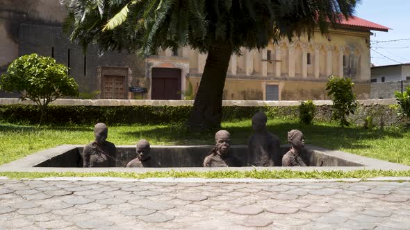 Slave memorial sculpture in Stone Town, Zanzibar, Africa, zooming shot. alt