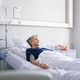 Lonely old woman lying on hospital bed - PhotoDune Item for Sale