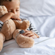 Little boy sleeping in hospital bed with teddy bear - PhotoDune Item for Sale