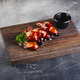 Chicken wings in teriyaki sauce on wooden cutting board - PhotoDune Item for Sale