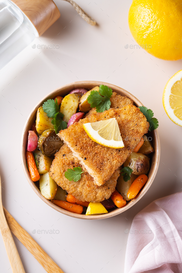 Vegan Plant based fish with crispy batter and roasted vegetables Stock