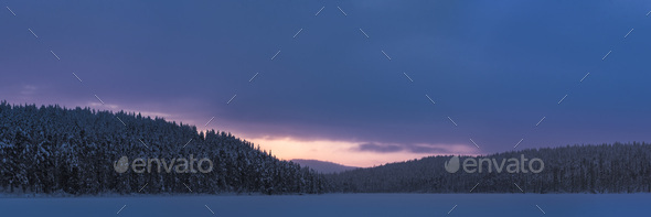 Frozen Snow Covered Lake In The Winter Landscape With Dramatic Sunset