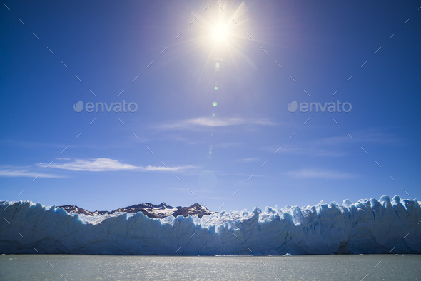 Sun melting glacier ice cap due to global warming and climate change causing environmental impact at