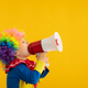 Funny kid clown playing against yellow background - PhotoDune Item for Sale