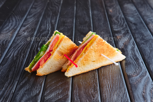 Appetizer for reception. Two mini club sandwich on wooden table Stock Photo  by boomeart