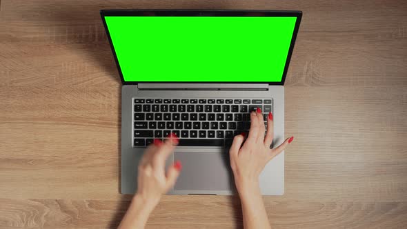 Closeup a Female Hands are Typing on Laptop Keyboard with Green Screen alt
