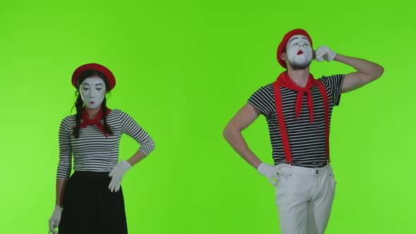 Mimes Talking On The Phone On A Green Background