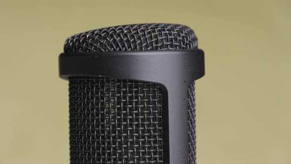 Studio Condenser Microphone Rotates on Yellow Background with Place for Text alt