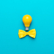Smart Idea with Yellow Bulb, Bow Tie on Turquoise Blue Background and Copy Space - PhotoDune Item for Sale