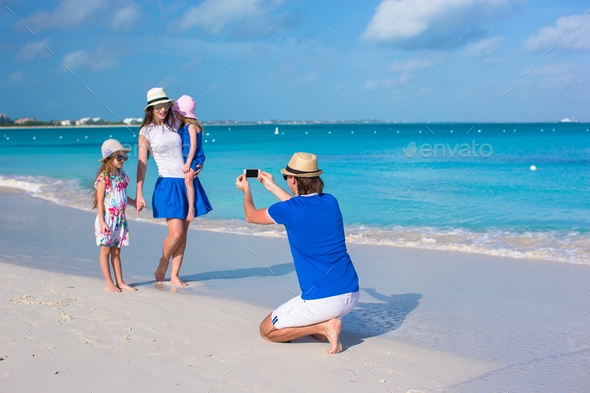 Happy family on caribbean holiday vacation Stock Photo by travnikovstudio