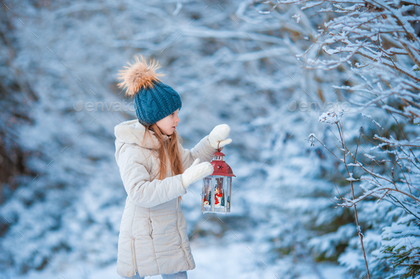 Adorable little girl wearing warm coat outdoors on Christmas day ...