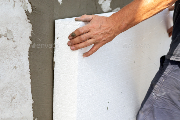 Insulation of facade wall with styrofoam sheets. Polystyrene insulation  boards with glue adhesive Stock Photo by bilanol