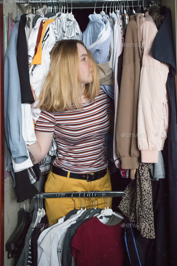 Spring cleaning,Fast fashion, the girl puts things in order in the closet. A bunch of colorful