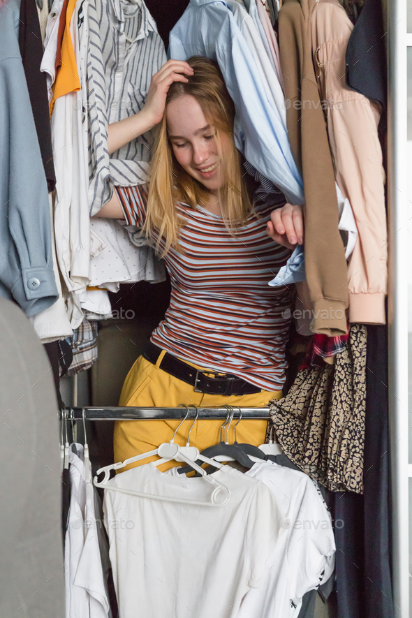 Spring cleaning,Fast fashion, the girl puts things in order in the closet. A bunch of colorful