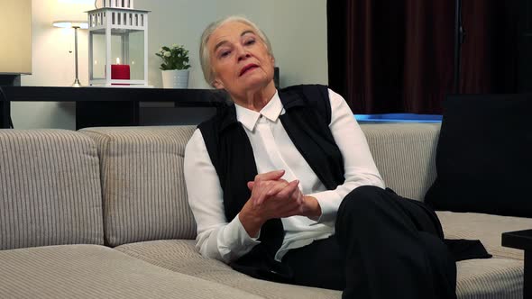Old Caucasian Woman Disagrees To Camera (Shake One's Head) in Living Room alt