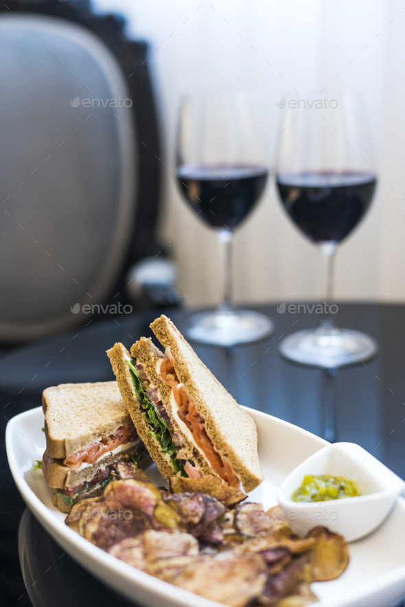 Delicious smoked salmon sandwich and glass of red wine at a luxury boutique hotel gastropub restaura