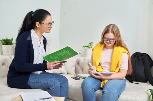 Female teacher studying individually with teenage girl