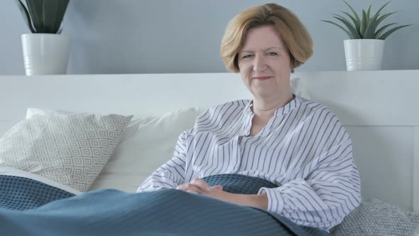 Smiling Old Senior Woman Sitting in Bed alt